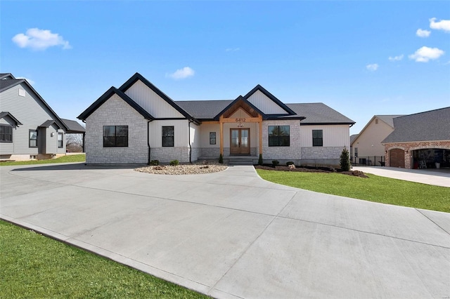 modern inspired farmhouse featuring stone siding, driveway, french doors, and a front yard