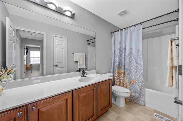 bathroom with tile patterned flooring, toilet, vanity, and visible vents