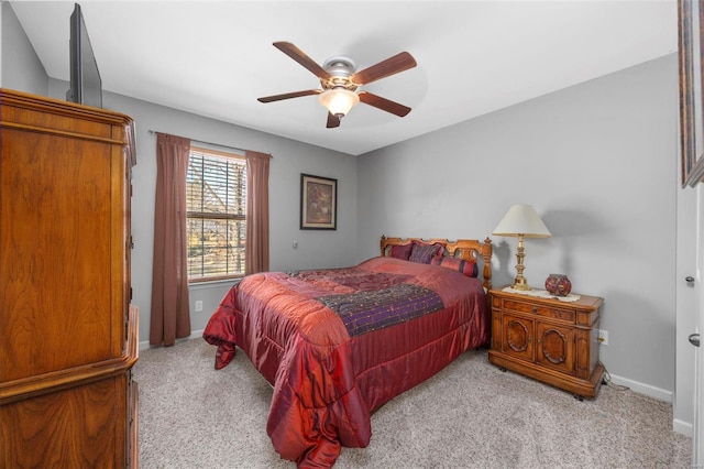 carpeted bedroom with a ceiling fan and baseboards