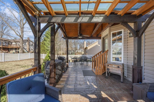 view of patio / terrace with ceiling fan, outdoor dining space, and fence