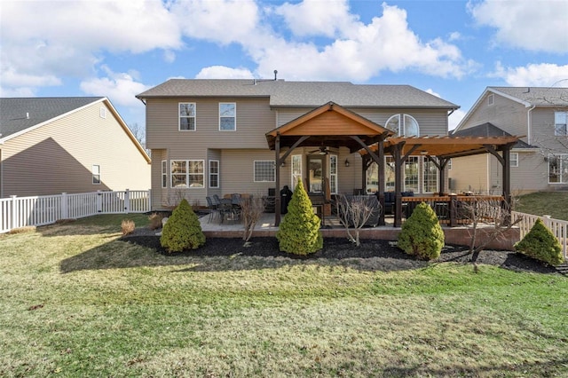 back of house featuring ceiling fan, a yard, a patio, and a fenced backyard