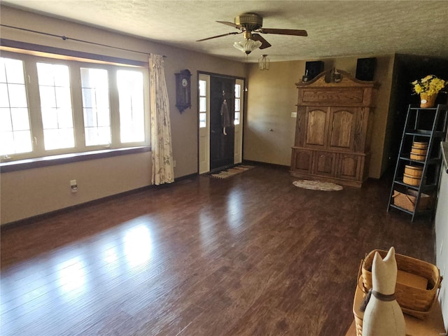 foyer with baseboards, a textured ceiling, ceiling fan, and wood finished floors