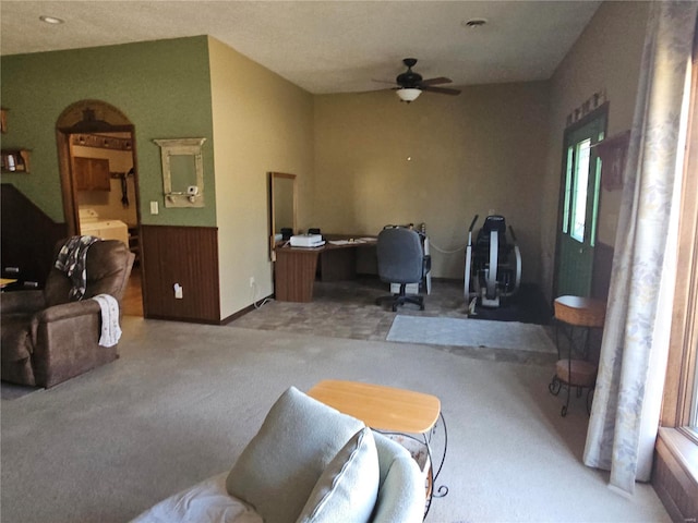 living area featuring carpet floors and a ceiling fan