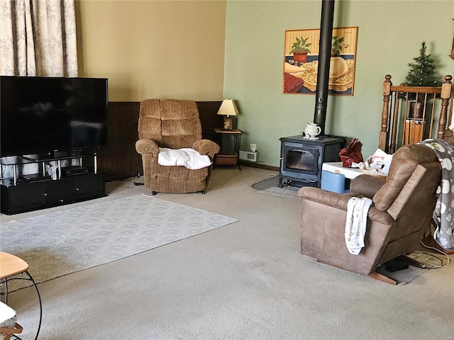 living room featuring a wood stove and carpet