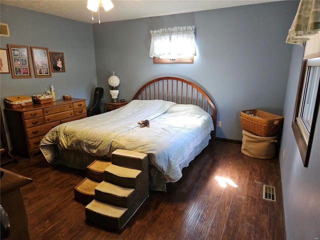 bedroom with wood finished floors and visible vents