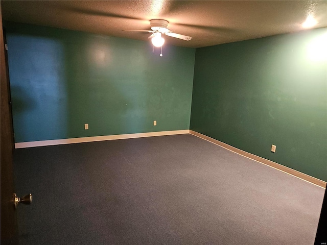 empty room featuring carpet flooring, a textured ceiling, baseboards, and a ceiling fan