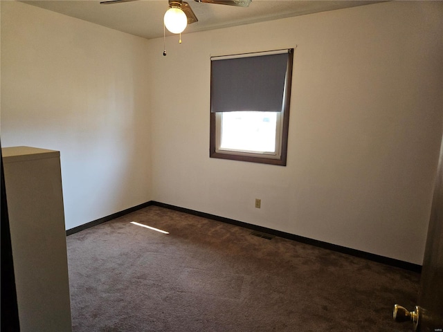 spare room with baseboards, carpet floors, visible vents, and ceiling fan