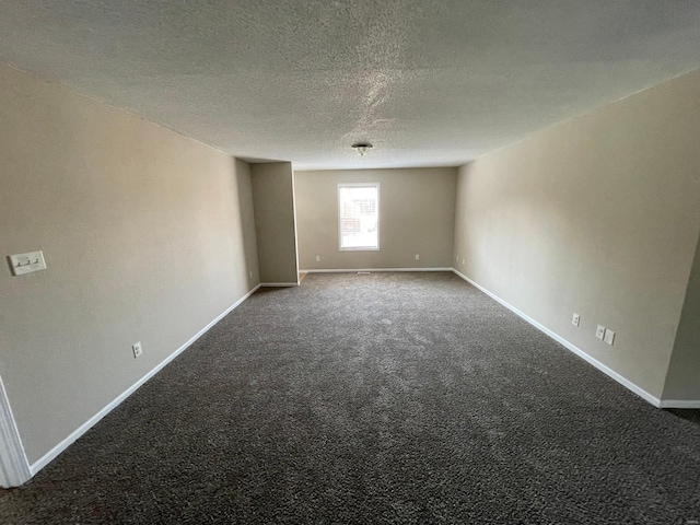 unfurnished room with baseboards, carpet floors, and a textured ceiling