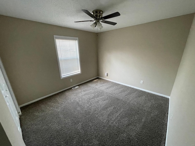 empty room with visible vents, a textured ceiling, baseboards, and carpet