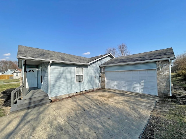 ranch-style house featuring an attached garage and concrete driveway
