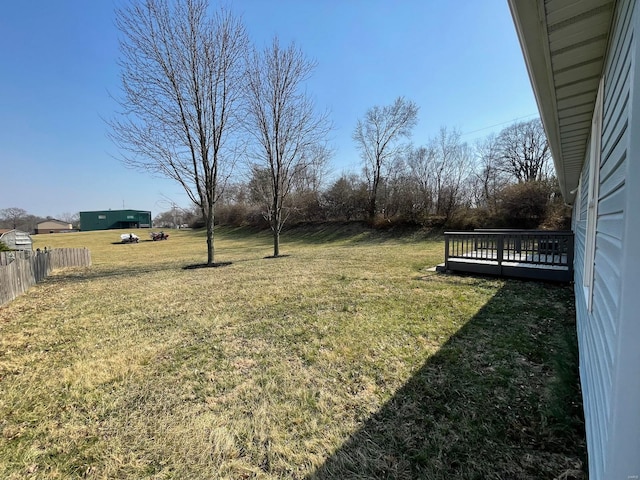 view of yard with a deck and fence