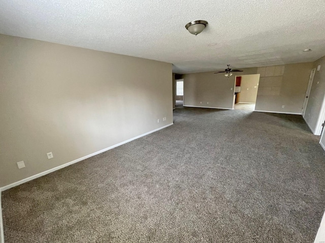 spare room featuring a textured ceiling, baseboards, dark carpet, and ceiling fan