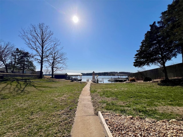 exterior space with a yard, a water view, and boat lift