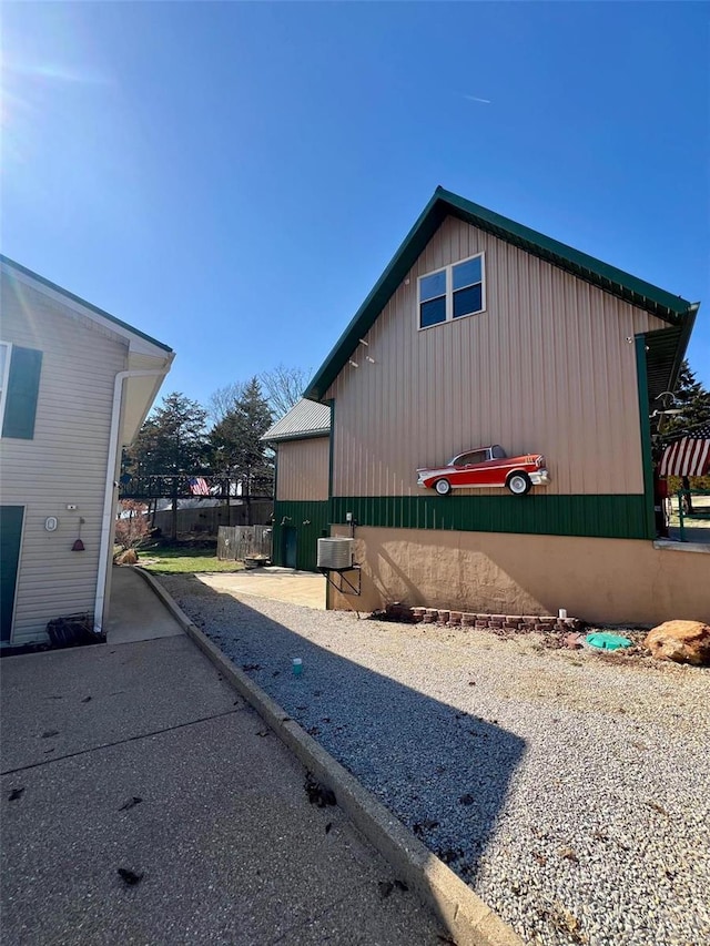 view of side of home featuring fence