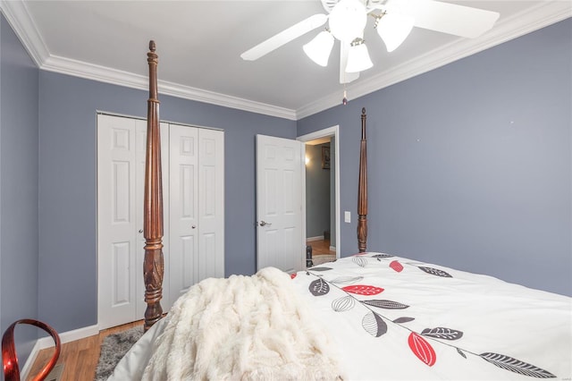 bedroom with baseboards, ornamental molding, wood finished floors, and ceiling fan