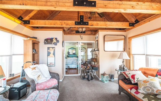 interior space with vaulted ceiling with beams, ceiling fan, wood ceiling, and baseboards