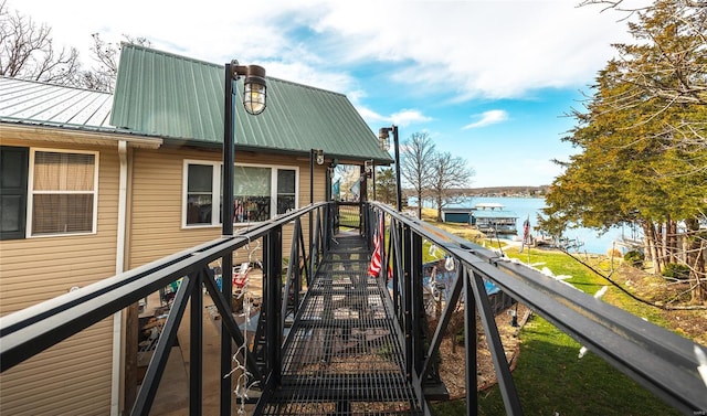 dock area featuring a water view and stairway