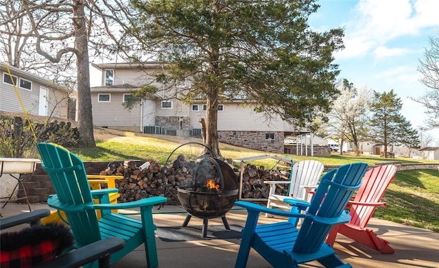 view of patio / terrace featuring a fire pit and a residential view