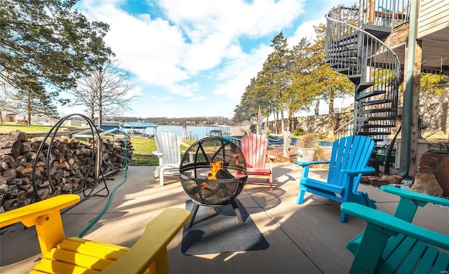 view of patio / terrace featuring a fire pit and stairs