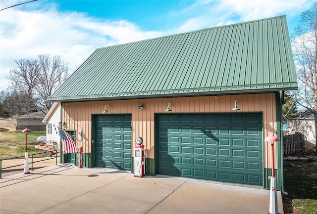 detached garage featuring fence
