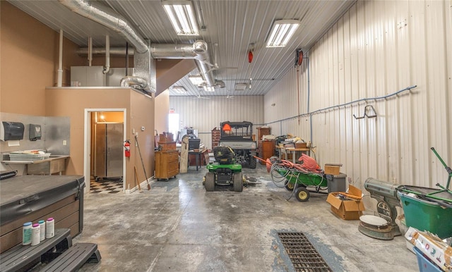 garage featuring metal wall and a workshop area