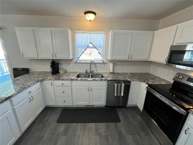 kitchen featuring a sink, stainless steel appliances, ornamental molding, and white cabinetry