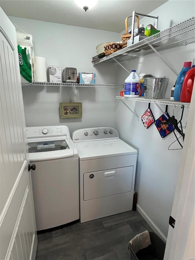 clothes washing area with laundry area, dark wood-style floors, baseboards, and independent washer and dryer