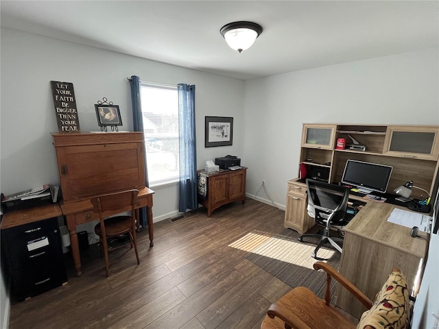 office space with visible vents, dark wood-type flooring, and baseboards