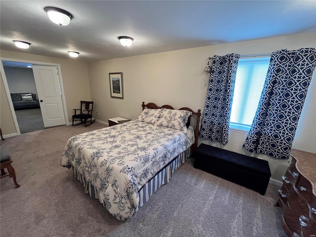 carpeted bedroom featuring baseboards