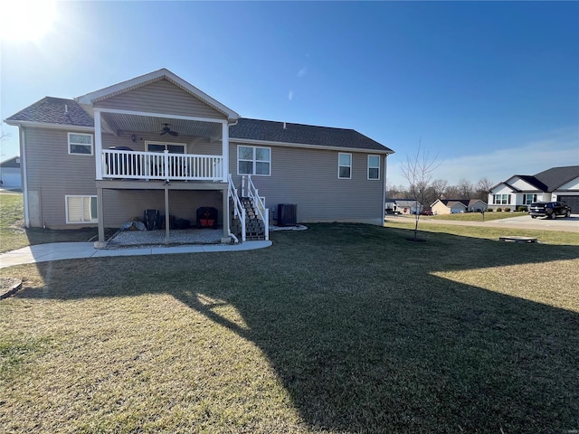 rear view of house featuring stairs, a yard, central AC unit, and a ceiling fan