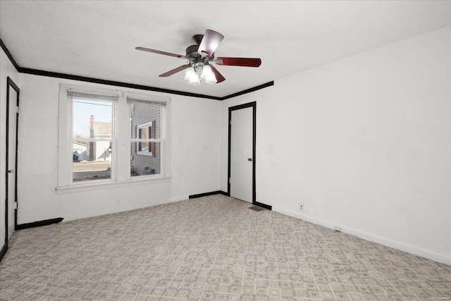 empty room with baseboards, carpet floors, and ornamental molding