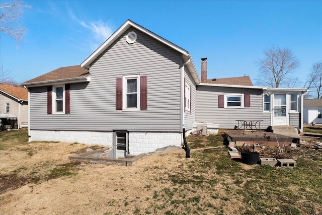 rear view of property featuring a patio area, a chimney, and a yard