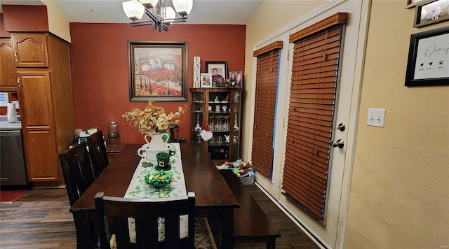 dining area with dark wood finished floors and a chandelier