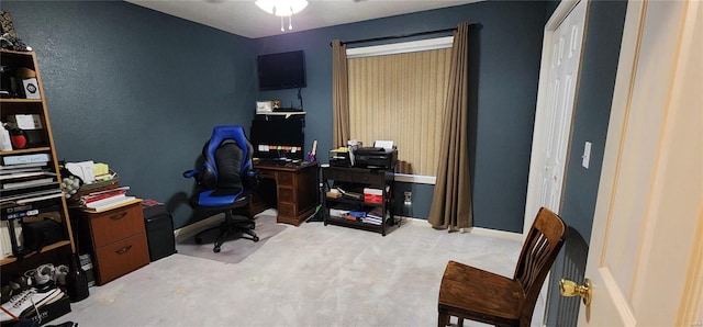 carpeted office space featuring a ceiling fan