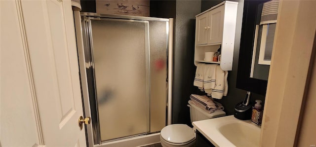 full bath featuring toilet, a stall shower, and vanity