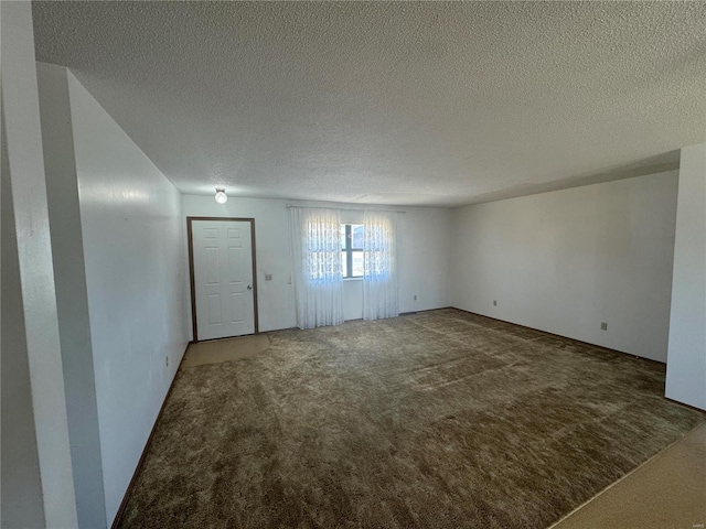 unfurnished living room featuring carpet and a textured ceiling