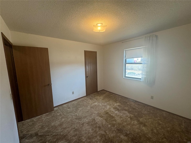 unfurnished bedroom with a closet, a textured ceiling, and carpet