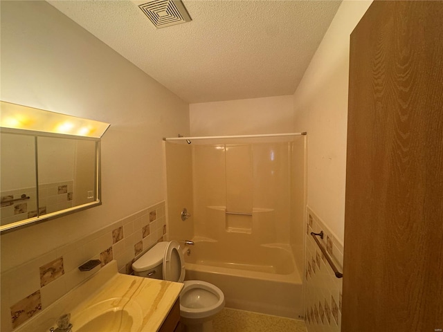 bathroom with visible vents,  shower combination, a textured ceiling, tile walls, and toilet