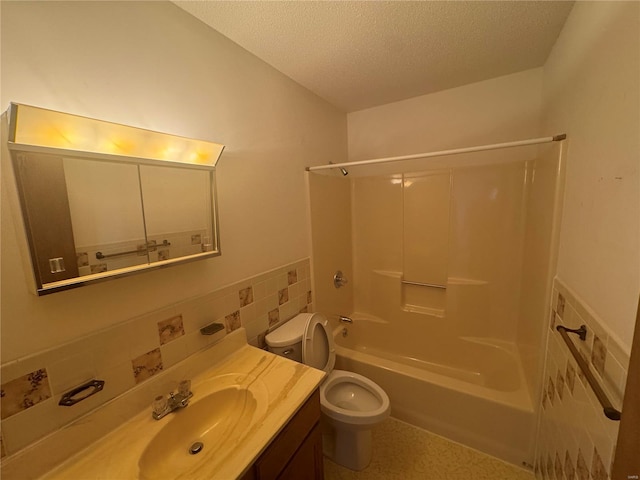 full bathroom with toilet, a textured ceiling, tile walls, bathing tub / shower combination, and vanity