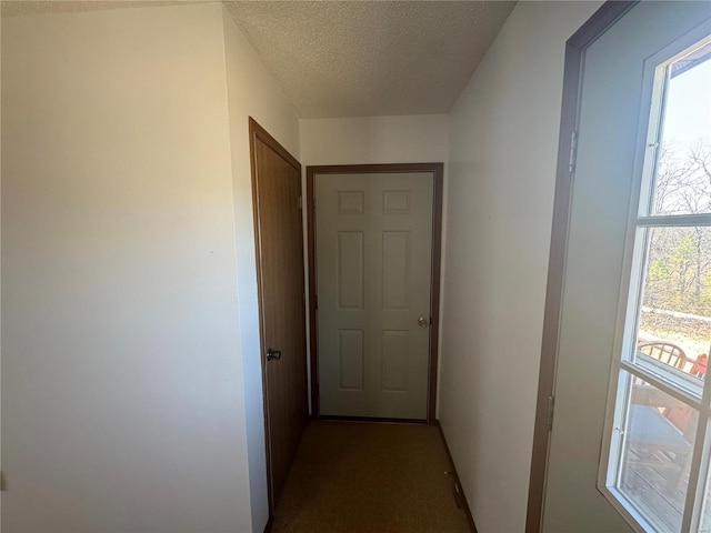 corridor featuring a textured ceiling