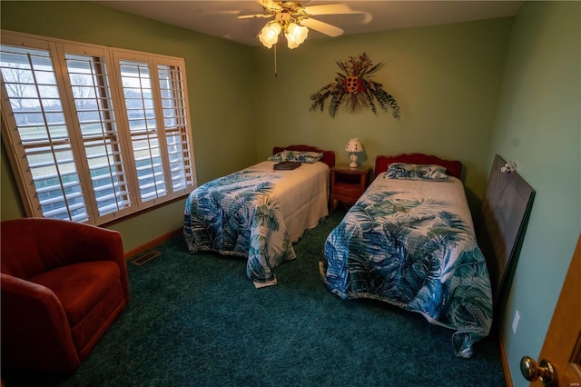 carpeted bedroom featuring visible vents, baseboards, and ceiling fan