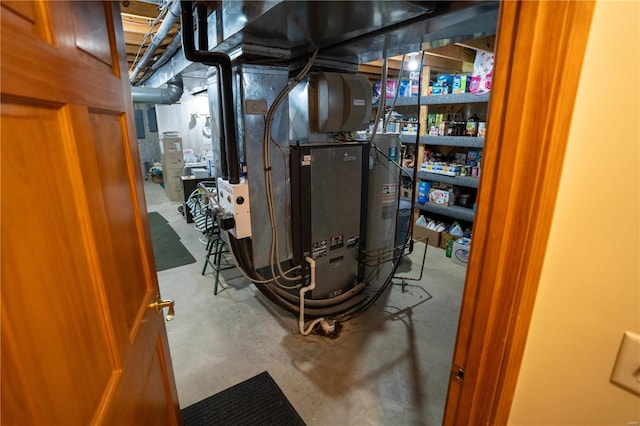 utility room featuring water heater and heating unit