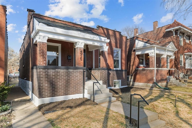 view of front of house featuring covered porch and brick siding