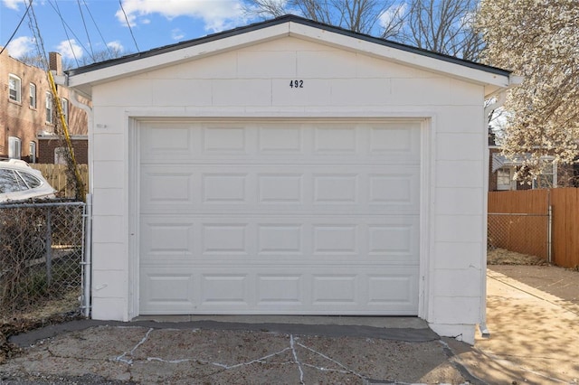 detached garage featuring fence