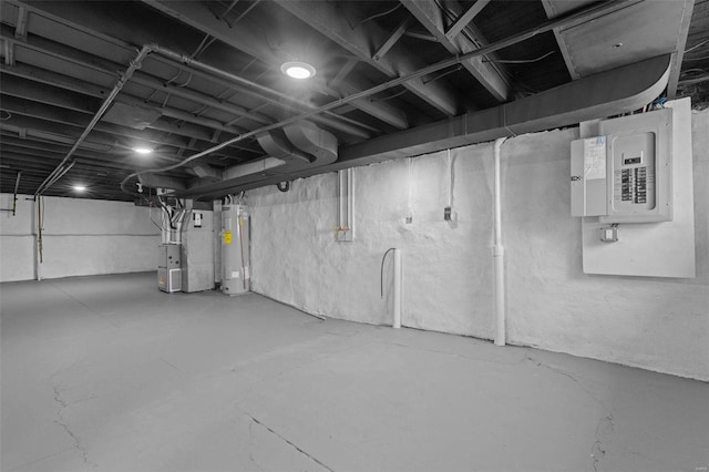 unfinished basement featuring electric panel, heating unit, and electric water heater