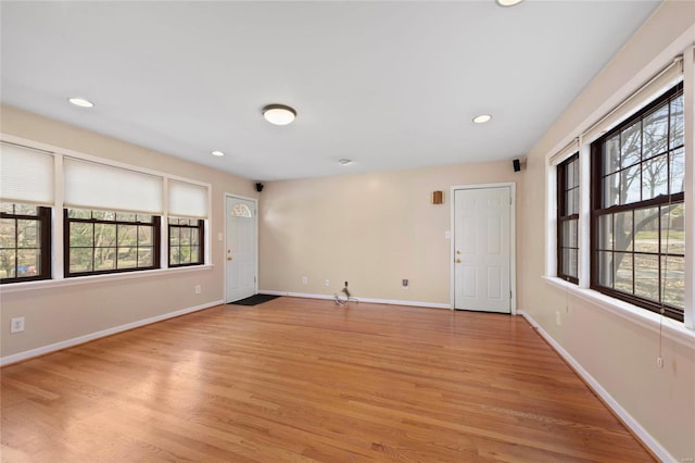 unfurnished room with recessed lighting, baseboards, and light wood finished floors