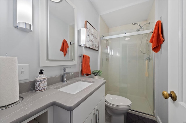 full bath featuring a shower stall, toilet, and vanity