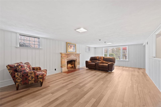 sitting room featuring light wood-type flooring and a fireplace