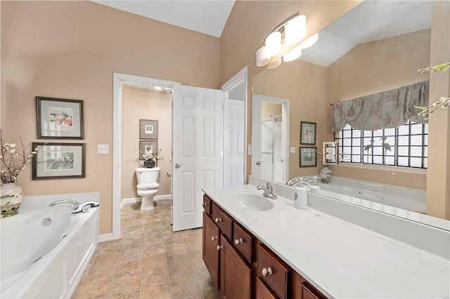 bathroom featuring baseboards, toilet, lofted ceiling, a bath, and vanity