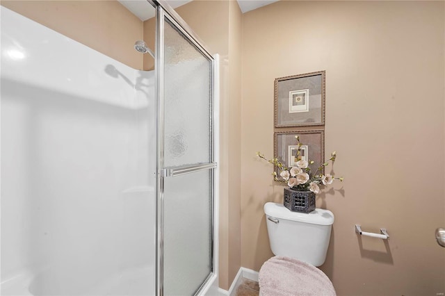 full bathroom with toilet and a shower stall